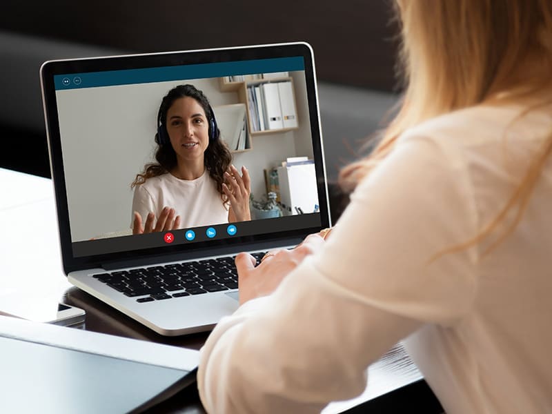 woman sitting at a desk with a laptop